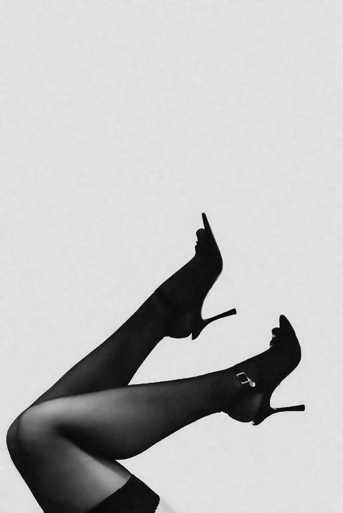 woman legs in black stocking and black heels