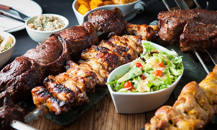 Top-down view of signature Brazilian churrasco grilled meat platter