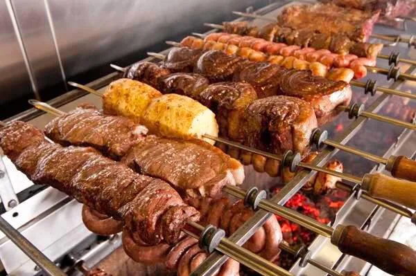 meat on skewers being grilled